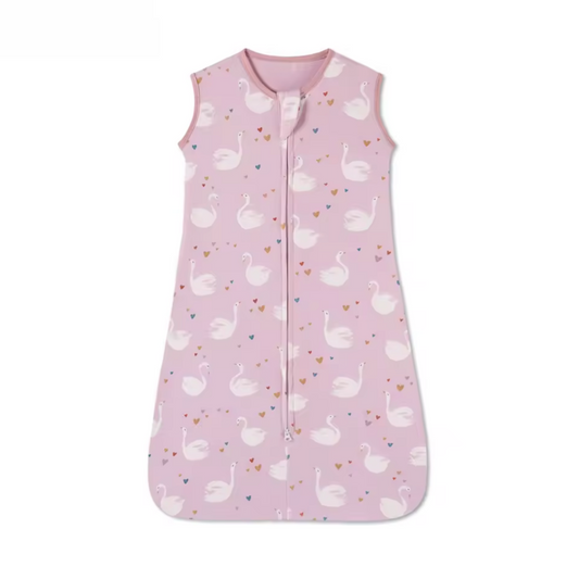 Pink baby sleeping bag with swan pattern on a white background