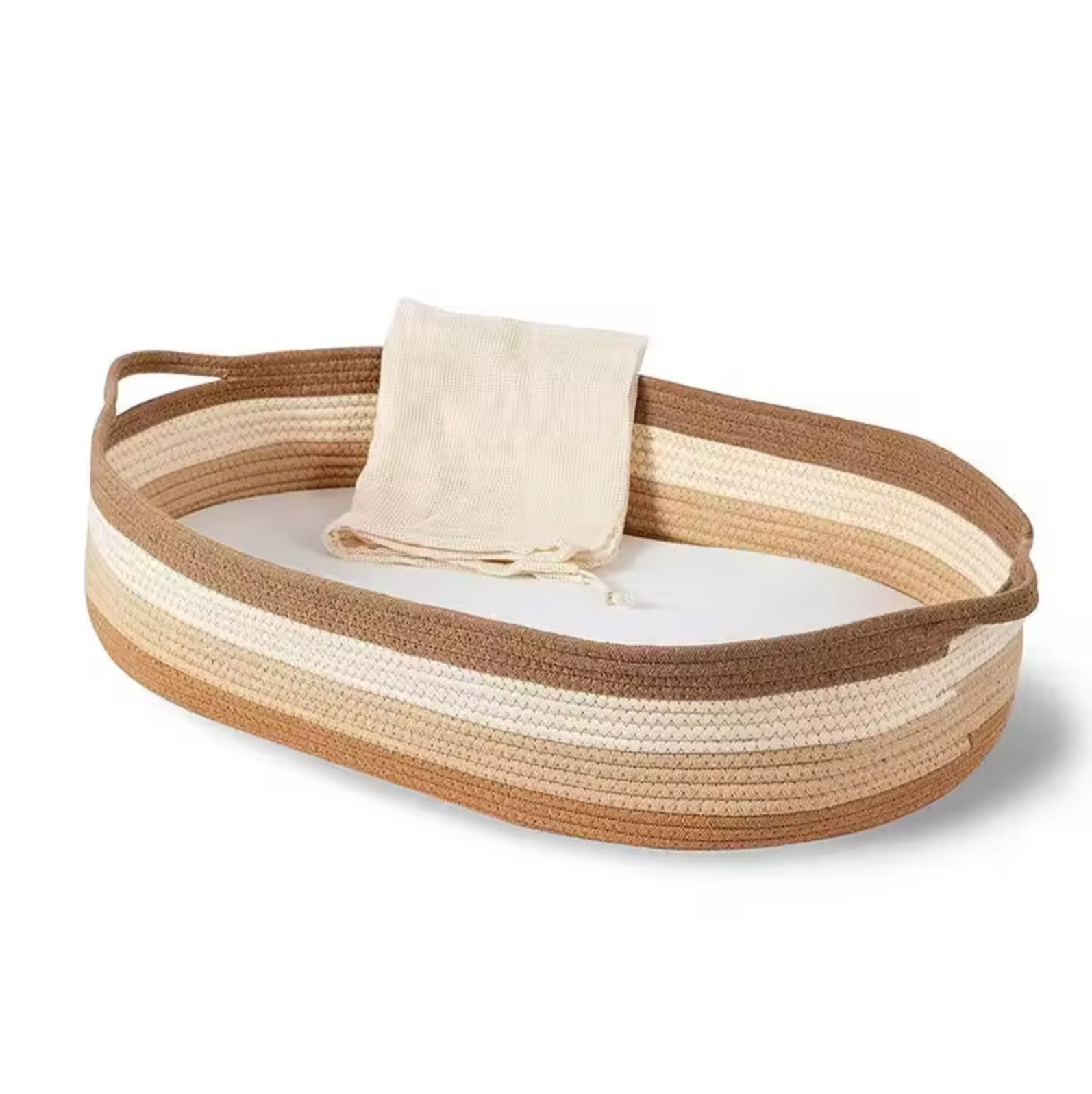 Woven basket with a beige towel on a white background